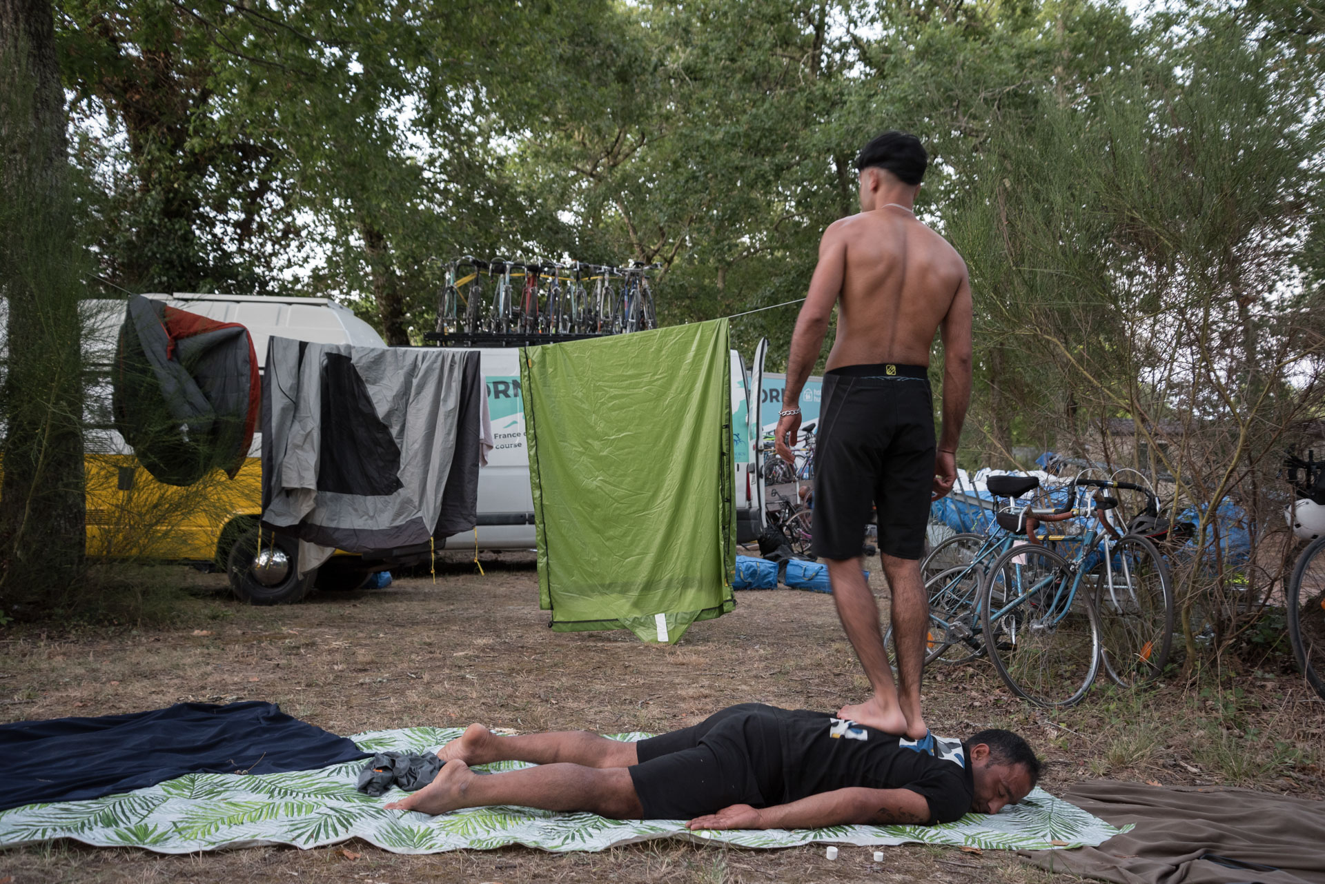 Two Afghan refugees, Niamatullah and Azizi, get massages by walking on each other s backs at the Villandraut campsite after a day s pedalling during the Reborn Trip cycling tour of France in the Nouvelle-Aquitaine region on August 8, 2024.
Deux refugies afghans, Niamatullah et Azizi se font des massages en se marchant sur le dos au camping de Villandraut apres une journee de pedalage pendant la traversee de la France a velo de Reborn Trip en Nouvelle-Aquitaine le 8 aout 2024.